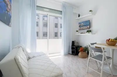 a living room with a white couch and a table at Host Wise - Sweet Flats - Bolhão City Center in Porto