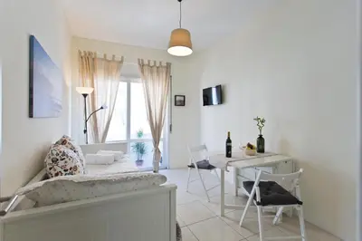 a living room with a couch and a table and chairs at Host Wise - Sweet Flats - Bolhão City Center in Porto