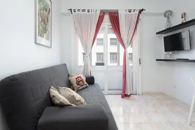 a living room with a couch and a window at Host Wise - Sweet Flats - Bolhão City Center in Porto