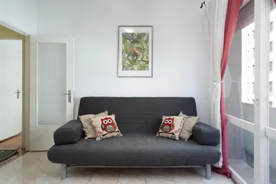 a black couch in a living room with a window at Host Wise - Sweet Flats - Bolhão City Center in Porto