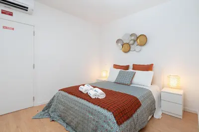 a bedroom with a bed with two stuffed animals on it at Host Wise - Sweet Sunny Flat with Balcony in Vila Nova de Gaia