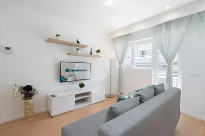 a living room with a couch and a tv at Host Wise - Sweet Sunny Flat with Balcony in Vila Nova de Gaia