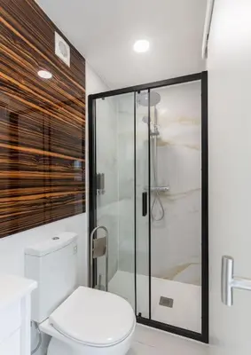 a bathroom with a toilet and a glass shower at Chic Loft with Garden, Sleeps 4 in Porto
