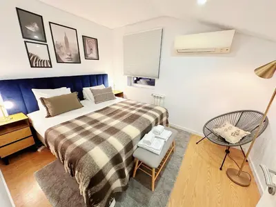 a bedroom with a bed and a desk and a chair at Downtown Premiu in center of Porto 3BR with AC in Porto