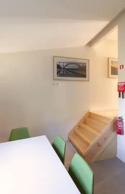 a room with a table and green chairs at GuestReady - Catorze de Outubro Houses 417 in Vila Nova de Gaia