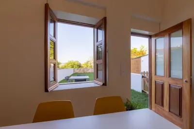 a room with a table and chairs and a window at GuestReady - Catorze de Outubro Houses 417 in Vila Nova de Gaia