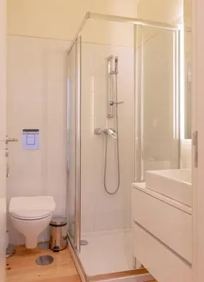 a bathroom with a shower and a toilet and a sink at GuestReady - Catorze de Outubro Houses 417 in Vila Nova de Gaia