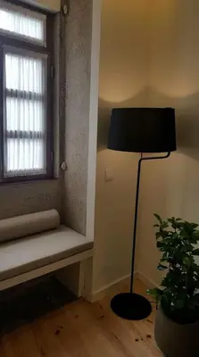 a room with a lamp and a window with a bench at GuestReady - Catorze de Outubro Houses 417 in Vila Nova de Gaia