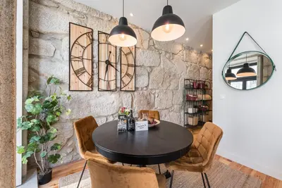 a dining room with a black table and chairs at GuestReady - Industrial stay in downtown Porto in Porto