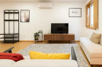 a living room with a tv and a couch at Host Wise - Elegant Home in the Heart of Porto in Porto