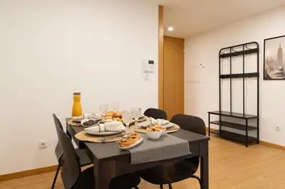 a dining room with a table with food on it at Host Wise - Elegant Home in the Heart of Porto in Porto