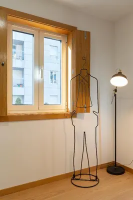 a mannequin in a room with a lamp and a window at Host Wise - Elegant Home in the Heart of Porto in Porto