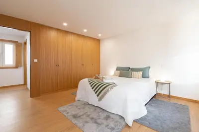 a bedroom with a large bed in a room at Host Wise - Elegant Home in the Heart of Porto in Porto