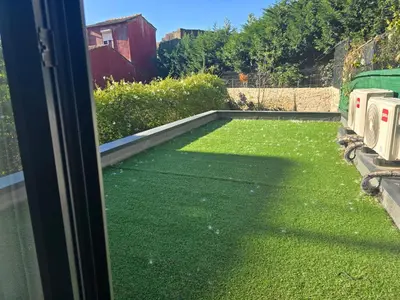 a view of a yard with green grass at Fontainhas Douro Flats in Porto