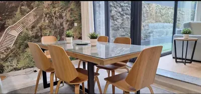 a dining room with a glass table and chairs at Fontainhas Douro Flats in Porto