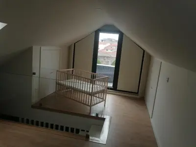 an empty room with a large window and a cage at Fontainhas Douro Flats in Porto