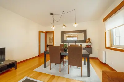 a dining room and living room with a table and chairs at Downtown Deluxe by Vacationy in Porto