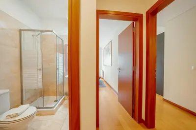 a bathroom with a toilet and a glass shower at Downtown Deluxe by Vacationy in Porto