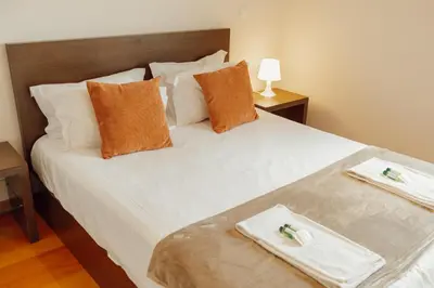 a bedroom with a large white bed with pillows at Downtown Deluxe by Vacationy in Porto