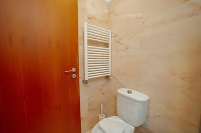 a bathroom with a white toilet and a window at Downtown Deluxe by Vacationy in Porto