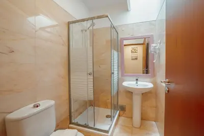 a bathroom with a shower and a toilet and a sink at Downtown Deluxe by Vacationy in Porto