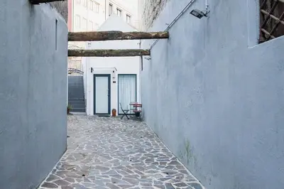 an empty alley with a table in a building at Vila Terra Studio III in Vila Nova de Gaia