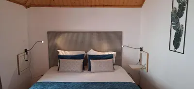 a bedroom with a bed with two pillows at Vila Terra Studio III in Vila Nova de Gaia