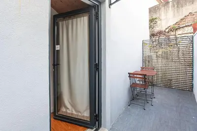 a sliding glass door to a balcony with a table at Vila Terra Studio III in Vila Nova de Gaia
