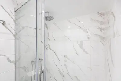a shower with a glass door in a bathroom at Vila Terra Studio III in Vila Nova de Gaia