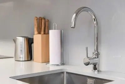 a kitchen sink with a faucet and a roll of paper towels at NEW LUX 2BR Flat Free Parking Cedofeita Porto in Porto