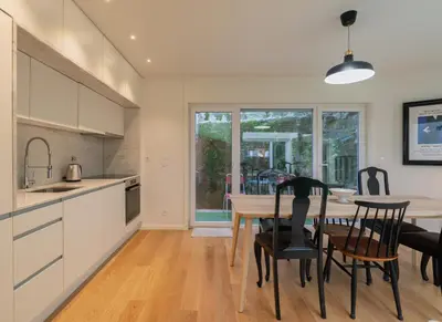 a kitchen and dining room with a table and chairs at Campanhã Duplex by Porto Stories in Porto
