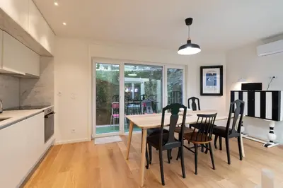 a kitchen and dining room with a table and chairs at Campanhã Duplex by Porto Stories in Porto