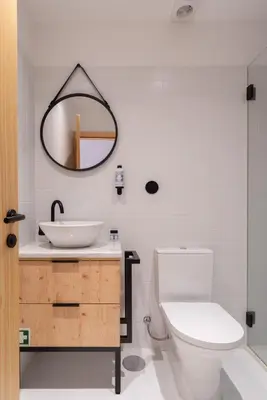 a bathroom with a sink and a toilet and a mirror at Prime Clerigos by Hosty in Porto