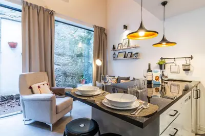 a kitchen and living room with a table and chairs at Vila Terra Studio Studio I in Vila Nova de Gaia