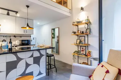 a kitchen and living room with a counter and a table at Vila Terra Studio Studio I in Vila Nova de Gaia