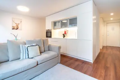 a living room with a couch and a kitchen at Bombarda 250 by LovelyStay in Porto