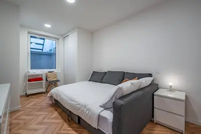 a bedroom with a bed and a window at Spritz Hour House in Porto
