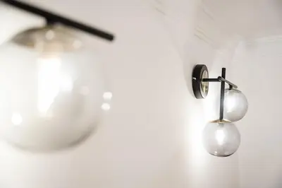 a pair of lights hanging on a wall next to a bowl at GuestReady - Mezzanine comfort in Porto in Porto