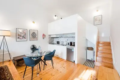 a kitchen and dining room with a table and chairs at GuestReady - Mezzanine comfort in Porto in Porto