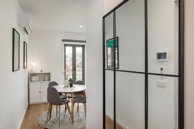 a kitchen and dining room with a table and chairs at Douro's Bridge View - Swimming pool in Vila Nova de Gaia