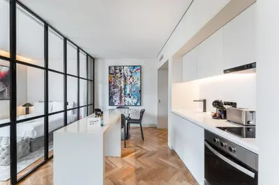 a kitchen with white countertops and glass walls at Sao Lazaro Premium Apartments in Porto