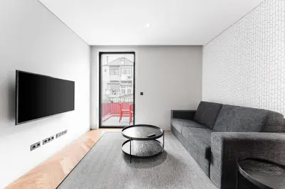 a living room with a couch and a tv at Sao Lazaro Premium Apartments in Porto