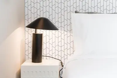 a black lamp on a white table in a room at Sao Lazaro Premium Apartments in Porto