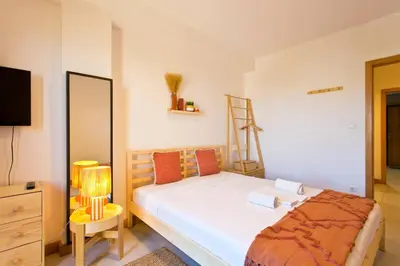 a bedroom with a bed and a dresser and a television at Aposentus - Contemporary Comfort in Porto