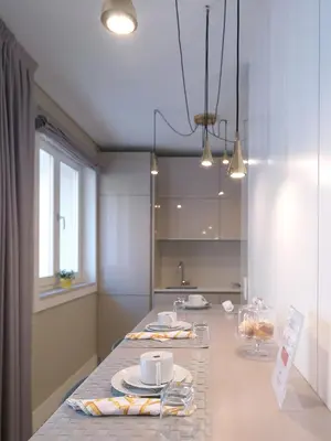a kitchen with a table with cups and plates on it at New Oporto Apartments - Cardosas in Porto