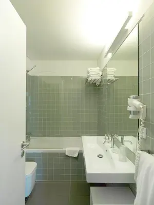 a bathroom with a sink and a tub and a mirror at New Oporto Apartments - Cardosas in Porto