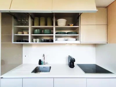a kitchen with white cabinets and a sink at Superb Apartment in the HEART of Historical Center in Porto