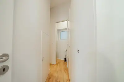 a hallway with white walls and a window at Downtown Elegant by Hosty in Porto