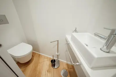 a white bathroom with a toilet and a sink at Downtown Elegant by Hosty in Porto