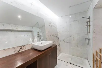 a white bathroom with a sink and a shower at City-Center Apartments with Mezzanine and Terrace in Porto